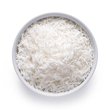 White bowl filled with shredded organic coconut flakes on a white background, top-down view
