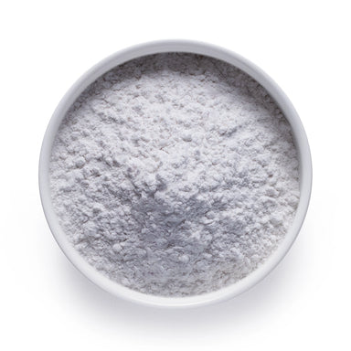 Bulk melatonin powder in a white ceramic bowl, wholesale superfood ingredient by Dolce Superfoods