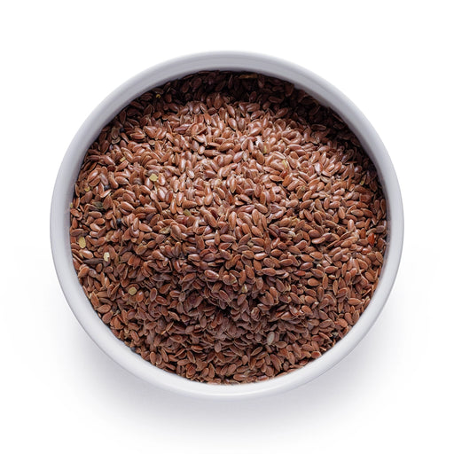 Bulk organic brown flax seeds in a white ceramic bowl, wholesale superfood ingredient by Dolce Superfoods