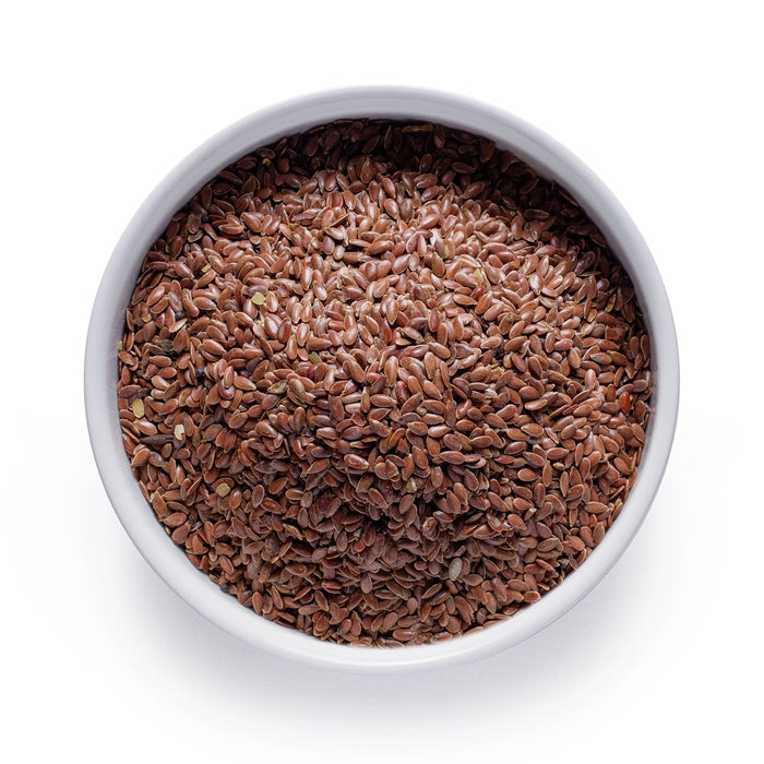 Bulk organic brown flax seeds in a white ceramic bowl, wholesale superfood ingredient by Dolce Superfoods
