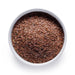 Bulk organic brown flax seeds in a white ceramic bowl, wholesale superfood ingredient by Dolce Superfoods