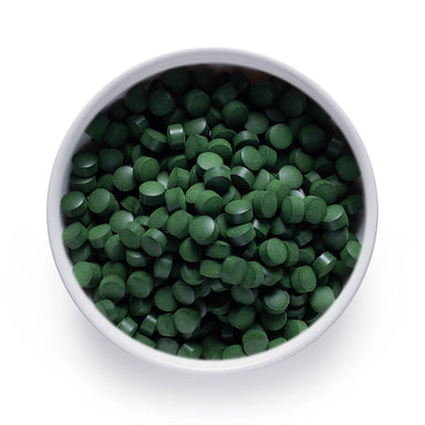 Bulk organic chlorella tablets in a white ceramic bowl, wholesale superfood ingredient by Dolce Superfoods
