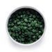Bulk organic chlorella tablets in a white ceramic bowl, wholesale superfood ingredient by Dolce Superfoods
