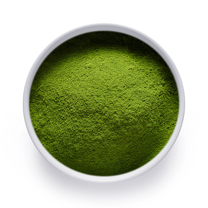A white bowl of vibrant Ceremonial Reserve Matcha Powder from Dolce Superfoods Wholesale
