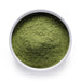 Bulk organic barley grass powder in a white ceramic bowl, wholesale superfood ingredient by Dolce Superfoods
