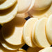 Dolce Superfoods cacao butter wafers close-up on dark background