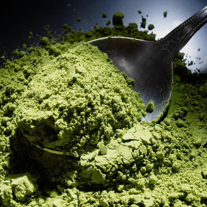Dolce Superfoods organic ceremonial matcha powder on metal spoon