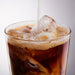 Dolce Superfoods organic instant coffee served iced with milk pouring into glass