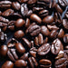 Dolce Superfoods organic whole bean coffee beans close up on dark surface