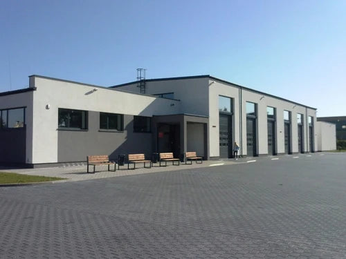 Modern building exterior with benches in front on a clear day