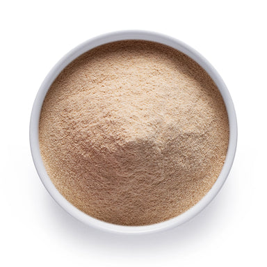 Organic date sugar in a white bowl, finely ground whole-date sweetener for bulk and wholesale baking, beverages, and clean-label recipes.