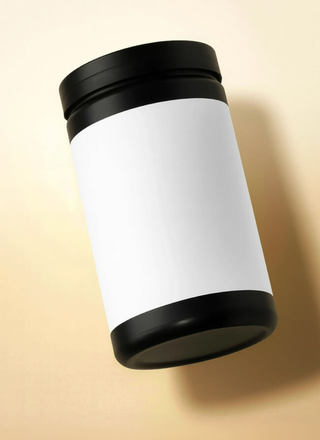 Tilted supplement jar with a black lid and blank white label, casting a soft shadow on a warm cream background, ready for private label branding.
